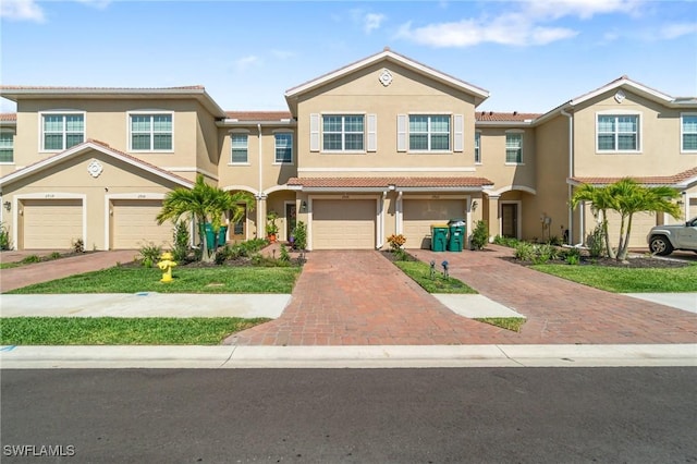 2926 Citrus St, Naples, FL 34120 - view of property with stucco siding, a tile roof, driveway, and a garage