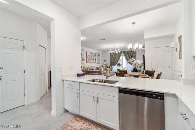 2926 Citrus St, Naples, FL 34120 - kitchen with stainless steel dishwasher, a sink, a peninsula, and a chandelier