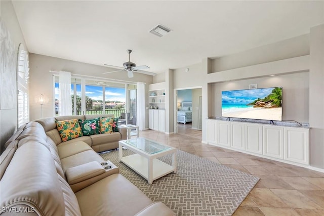 11384 Quail Village Way Unit 203, Naples, FL 34119 - living room featuring healthy amount of natural light, a ceiling fan, light tile patterned floors, and built in features