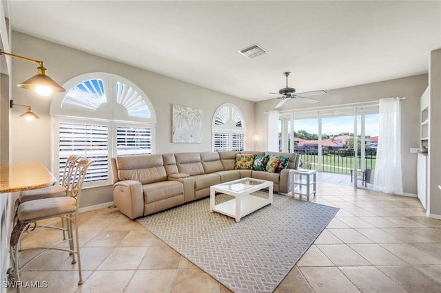 11384 Quail Village Way Unit 203, Naples, FL 34119 - living area with plenty of natural light, ceiling fan, and light tile patterned floors