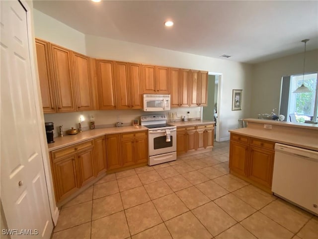 kitchen featuring recessed lighting, white appliances, light countertops, and decorative light fixtures