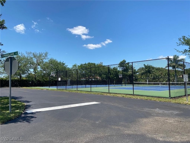 view of sport court featuring fence
