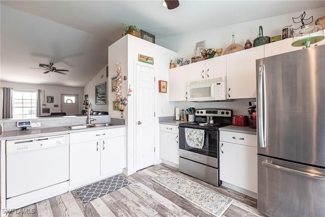 513 SE 27th Ter, Cape Coral, FL 33904 - kitchen with light wood-style flooring, vaulted ceiling, a sink, and appliances with stainless steel finishes