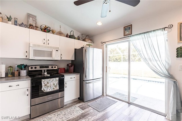 513 SE 27th Ter, Cape Coral, FL 33904 - kitchen featuring stainless steel appliances, light wood-style flooring, white cabinetry, and ceiling fan