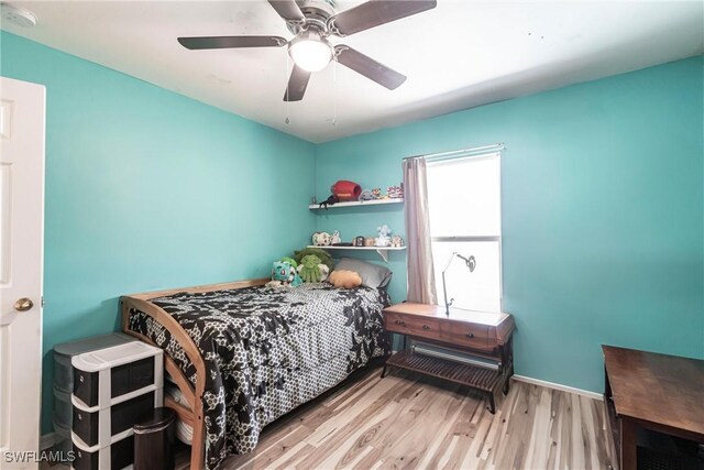 513 SE 27th Ter, Cape Coral, FL 33904 - bedroom with ceiling fan, wood finished floors, and baseboards
