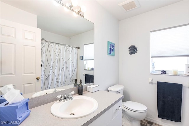 513 SE 27th Ter, Cape Coral, FL 33904 - bathroom with toilet, vanity, visible vents, and a shower with curtain