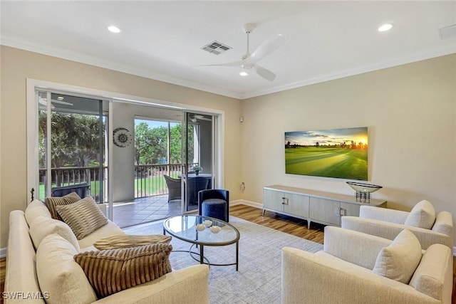 living room featuring a ceiling fan, ornamental molding, recessed lighting, and baseboards