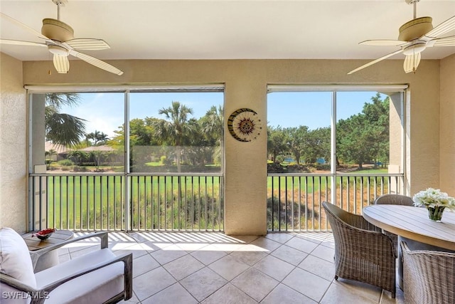 sunroom featuring ceiling fan