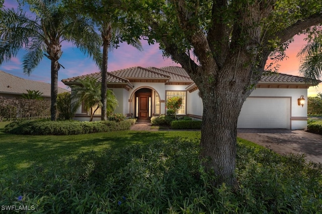 10326 Wishing Stone Ct, Bonita Springs, FL 34135 - mediterranean / spanish home with a yard, stucco siding, a tile roof, an attached garage, and driveway