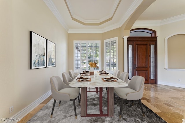 10326 Wishing Stone Ct, Bonita Springs, FL 34135 - dining room with crown molding, decorative columns, arched walkways, stone finish flooring, and baseboards