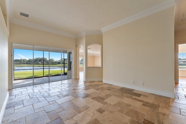 10326 Wishing Stone Ct, Bonita Springs, FL 34135 - unfurnished room featuring ornamental molding, stone tile flooring, baseboards, and a healthy amount of sunlight