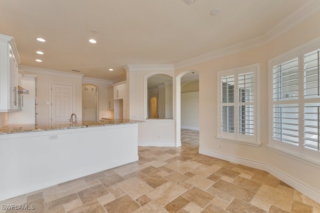 10326 Wishing Stone Ct, Bonita Springs, FL 34135 - kitchen with ornamental molding, white cabinetry, light stone counters, and stone tile floors