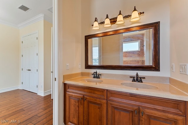10326 Wishing Stone Ct, Bonita Springs, FL 34135 - bathroom featuring a sink, visible vents, double vanity, and crown molding