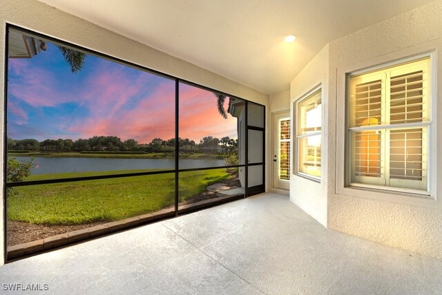10326 Wishing Stone Ct, Bonita Springs, FL 34135 - unfurnished sunroom with a textured wall, lofted ceiling, and a water view