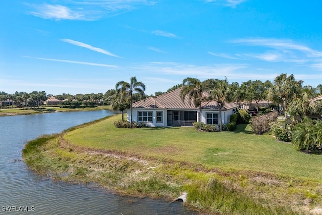 10326 Wishing Stone Ct, Bonita Springs, FL 34135 - rear view of property with a tiled roof, a water view, a lawn, and stucco siding