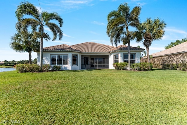 10326 Wishing Stone Ct, Bonita Springs, FL 34135 - back of house with a sunroom, stucco siding, a tile roof, and a lawn