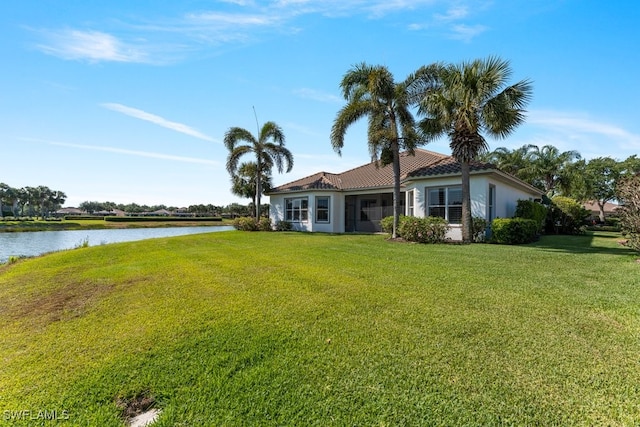 10326 Wishing Stone Ct, Bonita Springs, FL 34135 - exterior space with a water view, a front yard, a tiled roof, and stucco siding