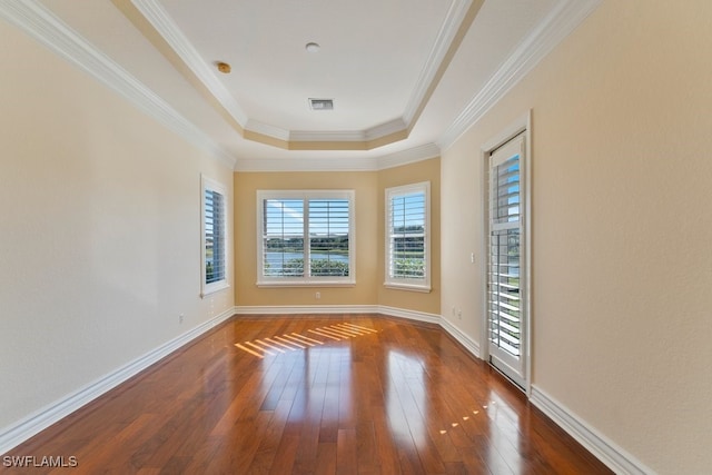 10326 Wishing Stone Ct, Bonita Springs, FL 34135 - empty room featuring visible vents, baseboards, a raised ceiling, and wood-type flooring