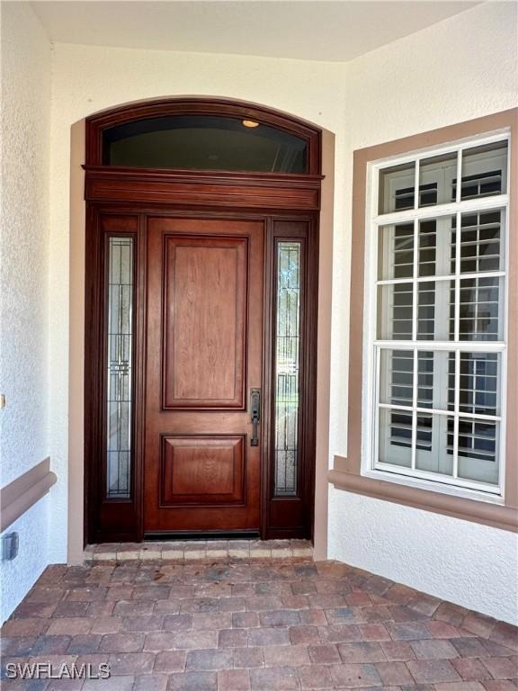 10326 Wishing Stone Ct, Bonita Springs, FL 34135 - entrance to property with a porch and stucco siding