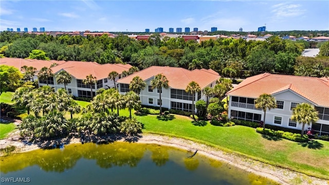 birds eye view of property featuring a city view and a water view