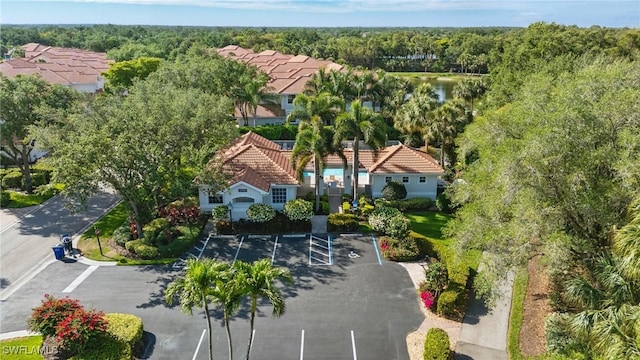 bird's eye view with a wooded view