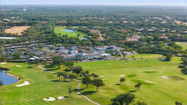 birds eye view of property featuring view of golf course, a water view, and a residential view