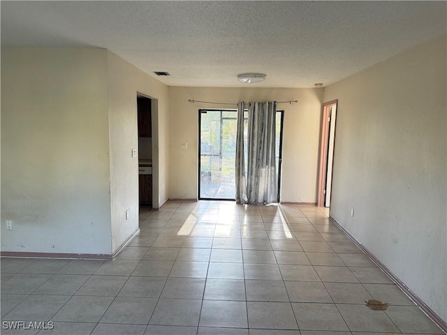 338 Melody Ct, Fort Myers, FL 33916 - unfurnished room with light tile patterned floors, a textured ceiling, and baseboards