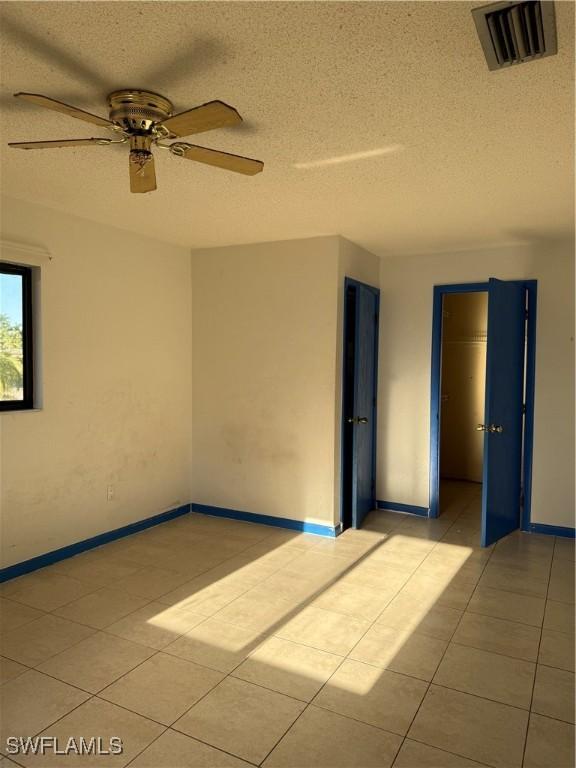 338 Melody Ct, Fort Myers, FL 33916 - unfurnished room with light tile patterned floors, a textured ceiling, ceiling fan, and baseboards