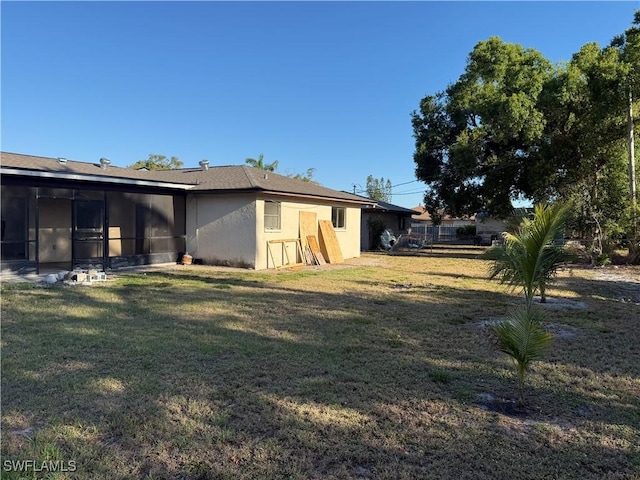 338 Melody Ct, Fort Myers, FL 33916 - view of grassy yard with a sunroom