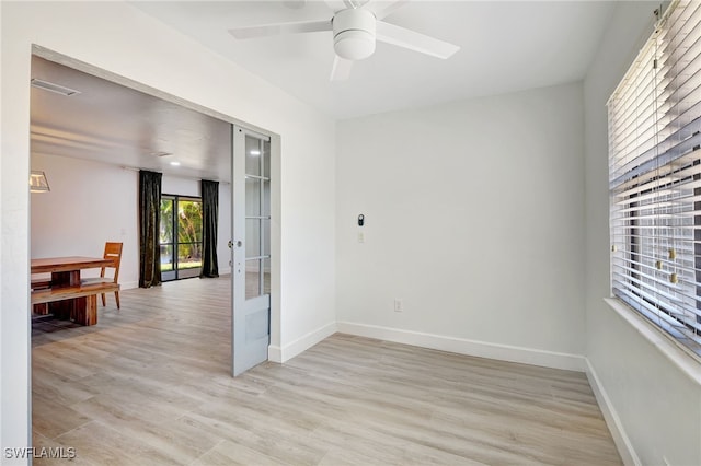 2226 SE 19th Pl, Cape Coral, FL 33990 - spare room featuring light wood finished floors, baseboards, a ceiling fan, and french doors