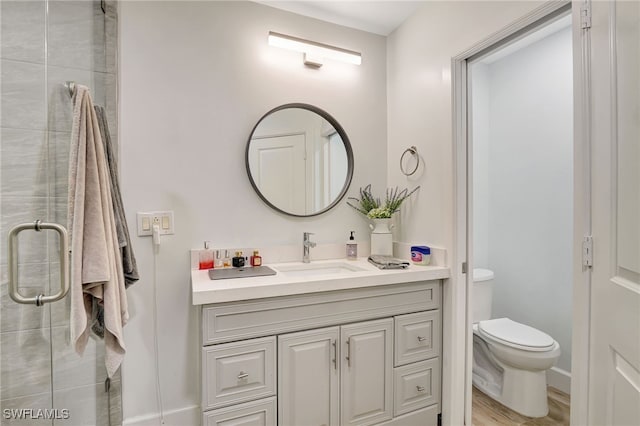 2226 SE 19th Pl, Cape Coral, FL 33990 - full bath with toilet, wood finished floors, a stall shower, vanity, and baseboards