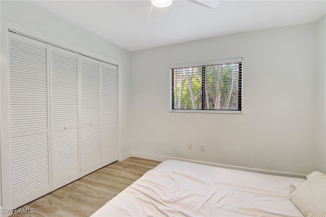 2226 SE 19th Pl, Cape Coral, FL 33990 - bedroom featuring ceiling fan, baseboards, light wood-style flooring, and a closet
