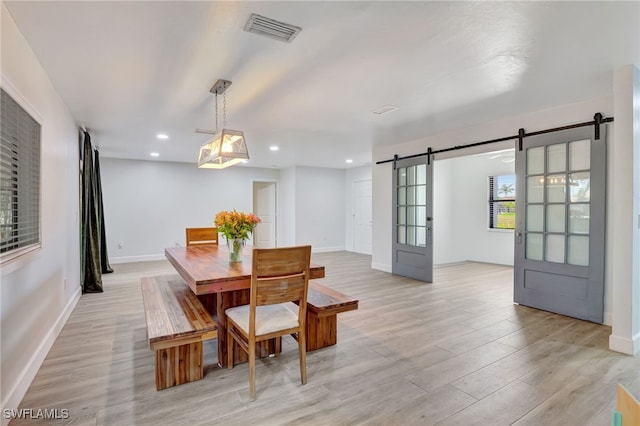 2226 SE 19th Pl, Cape Coral, FL 33990 - dining area with light wood-type flooring, baseboards, recessed lighting, a barn door, and visible vents