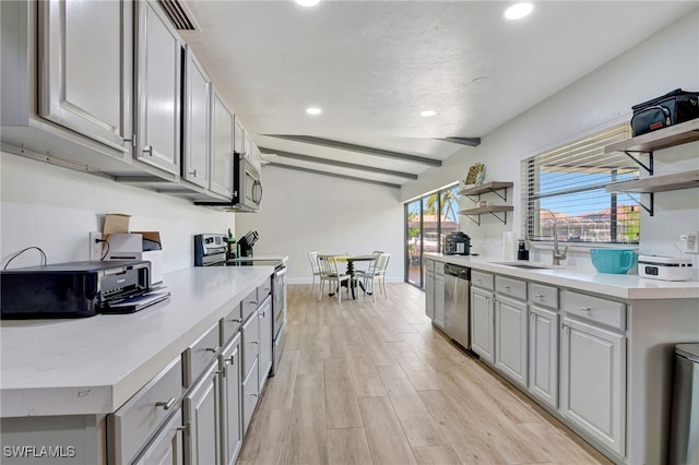 2226 SE 19th Pl, Cape Coral, FL 33990 - kitchen featuring a sink, open shelves, gray cabinetry, and stainless steel appliances