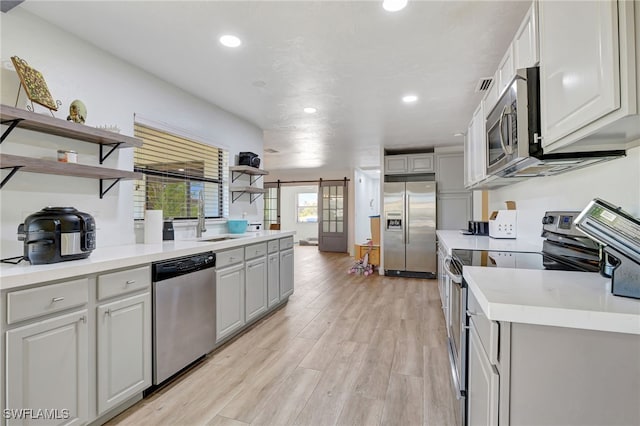 2226 SE 19th Pl, Cape Coral, FL 33990 - kitchen featuring stainless steel appliances, recessed lighting, light wood finished floors, and open shelves