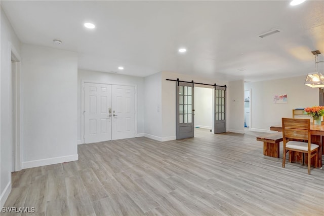 2226 SE 19th Pl, Cape Coral, FL 33990 - entryway featuring visible vents, baseboards, light wood finished floors, and a barn door