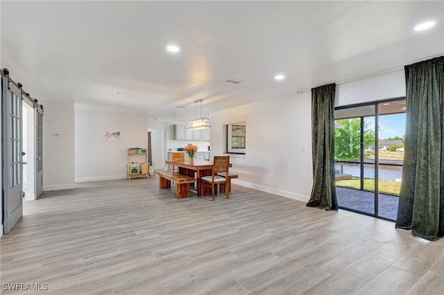 2226 SE 19th Pl, Cape Coral, FL 33990 - dining space featuring a barn door, light wood finished floors, baseboards, and recessed lighting