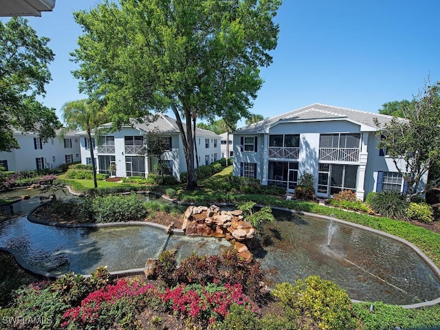 view of home's community featuring a garden pond