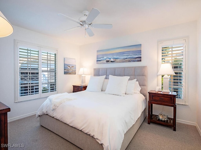 bedroom with baseboards, multiple windows, and carpet flooring