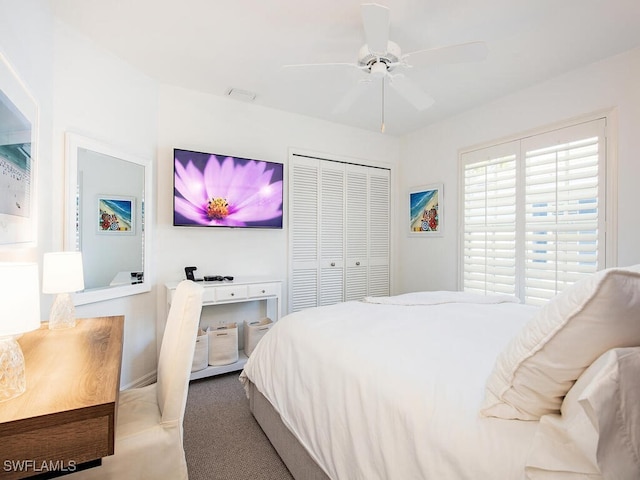 carpeted bedroom featuring visible vents, a ceiling fan, and a closet