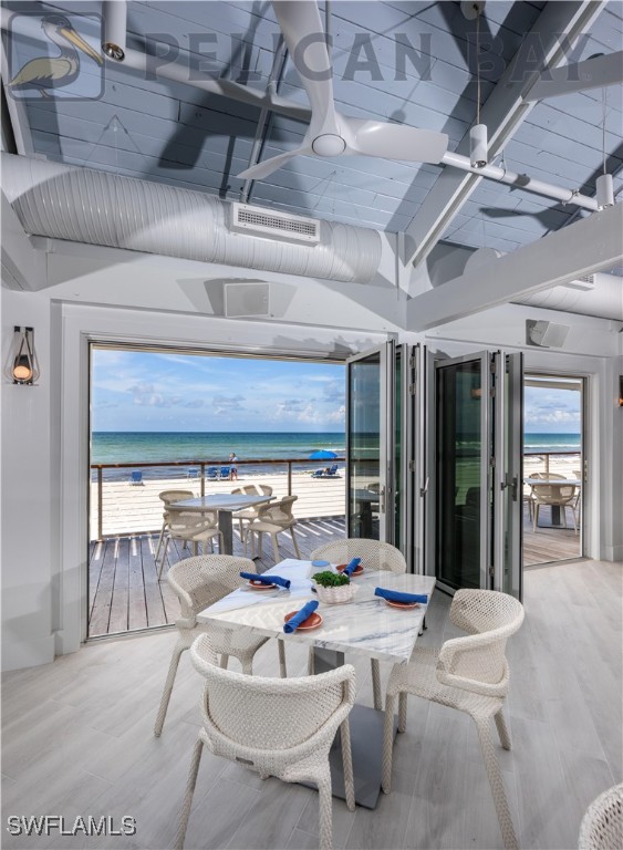 dining room featuring visible vents, wood finished floors, and a water view
