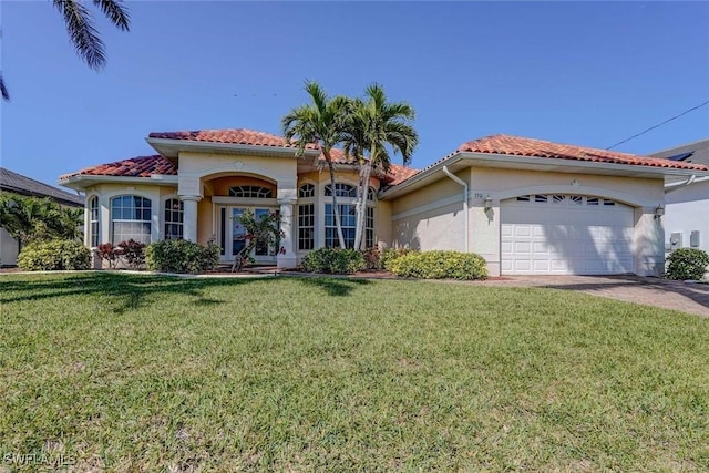 330 SW 33rd Ave, Cape Coral, FL 33991 - mediterranean / spanish-style home with stucco siding, a front yard, a tile roof, and a garage