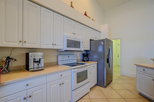 330 SW 33rd Ave, Cape Coral, FL 33991 - kitchen featuring white appliances, light countertops, and white cabinets