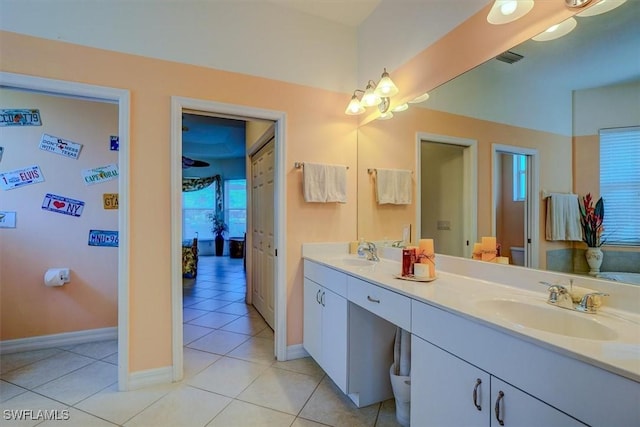 330 SW 33rd Ave, Cape Coral, FL 33991 - bathroom featuring tile patterned flooring, a sink, double vanity, and baseboards