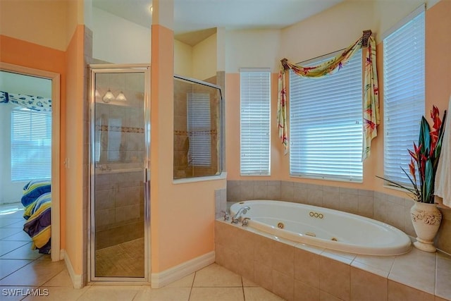 330 SW 33rd Ave, Cape Coral, FL 33991 - ensuite bathroom with a shower stall, a whirlpool tub, baseboards, tile patterned flooring, and ensuite bathroom