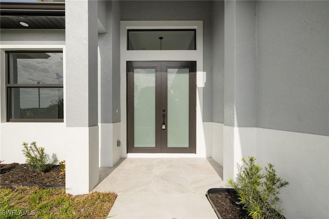 1042 Bassinger Ave S, Lehigh Acres, FL 33974 - entrance to property with french doors and stucco siding