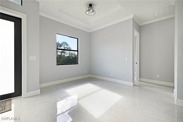 1042 Bassinger Ave S, Lehigh Acres, FL 33974 - empty room with a tray ceiling, marble finish floor, baseboards, and ornamental molding