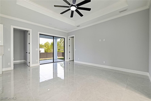 1042 Bassinger Ave S, Lehigh Acres, FL 33974 - unfurnished room featuring crown molding, ceiling fan, a raised ceiling, and baseboards