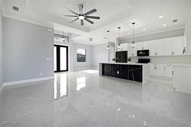 1042 Bassinger Ave S, Lehigh Acres, FL 33974 - kitchen featuring a center island, open floor plan, crown molding, a tray ceiling, and black appliances