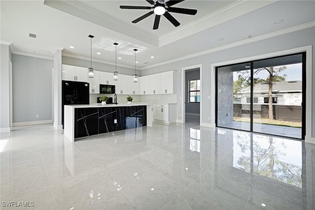 1042 Bassinger Ave S, Lehigh Acres, FL 33974 - kitchen with white cabinets, modern cabinets, a ceiling fan, black appliances, and a spacious island